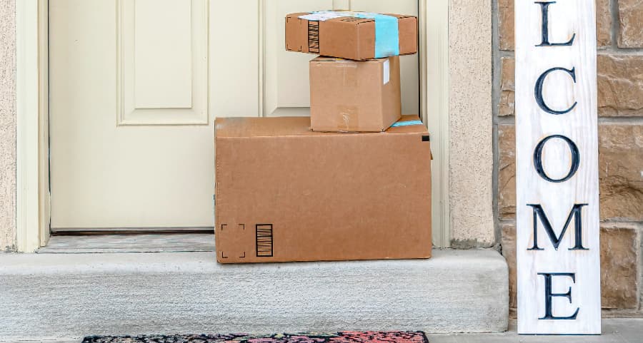 Deliveries on the front porch of a house with a welcome sign in Fort Collins